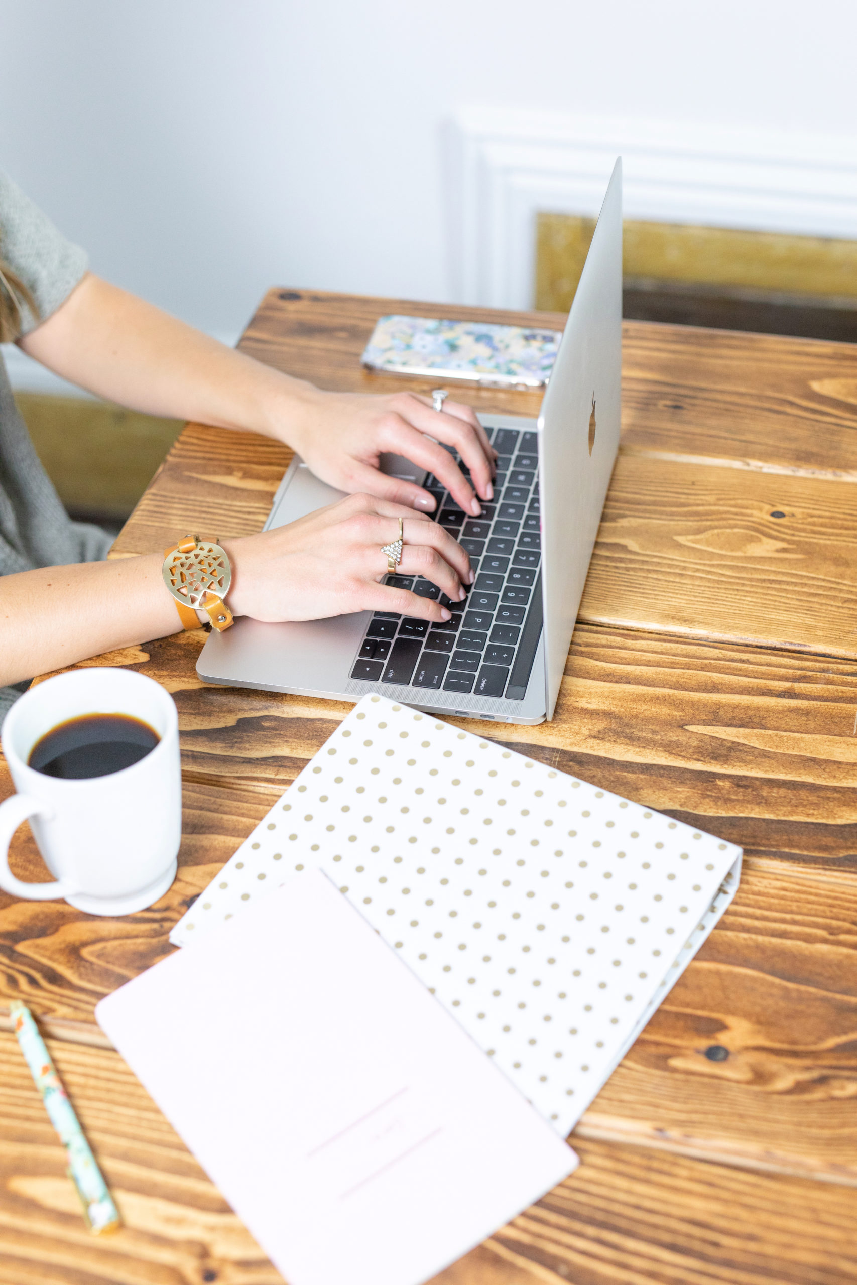 hands on keyboard with coffee and pretty desk