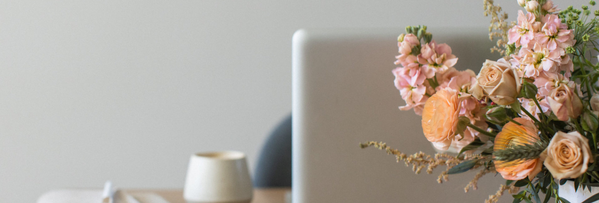 floral arrangement in front of laptop computer on desk ready to work