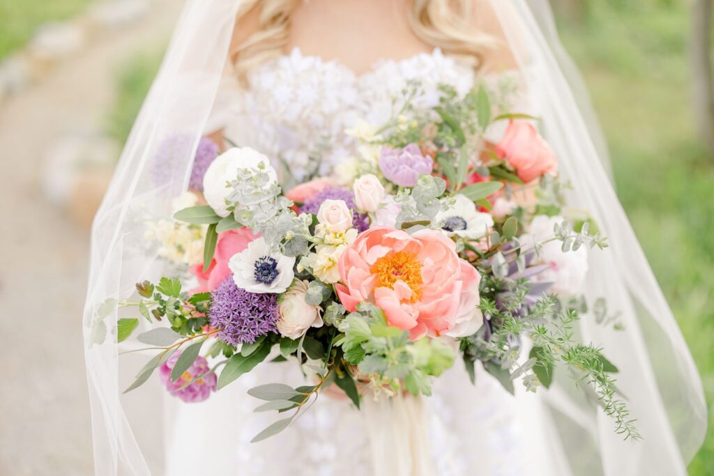 bride holding colorful wedding bouquet