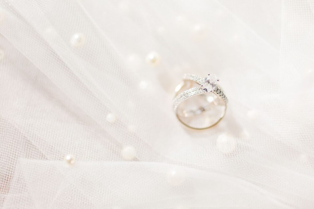 wedding ring details shot on pearl veil