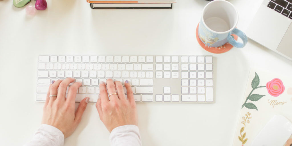 hands on keyboard pretty desk